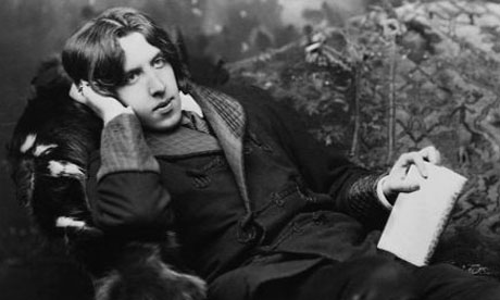 A portrait of poet and novelist, Oscar Wilde, (1854-1900), known for his languid poses and typical costume including a velvet robe and black silk stockings.  Wilde was popular for his wit and satire of Victorian society, which was apparent in his work  --- Image by    CORBIS 1 British English Europeans Full-length portraits Full-length studio portraits Gay man Irish Literary arts Males N. Sarony Oscar Wilde People Photographers Poet Portraits Prominent persons Sexual preference Studio portraits Whites Writer Writer